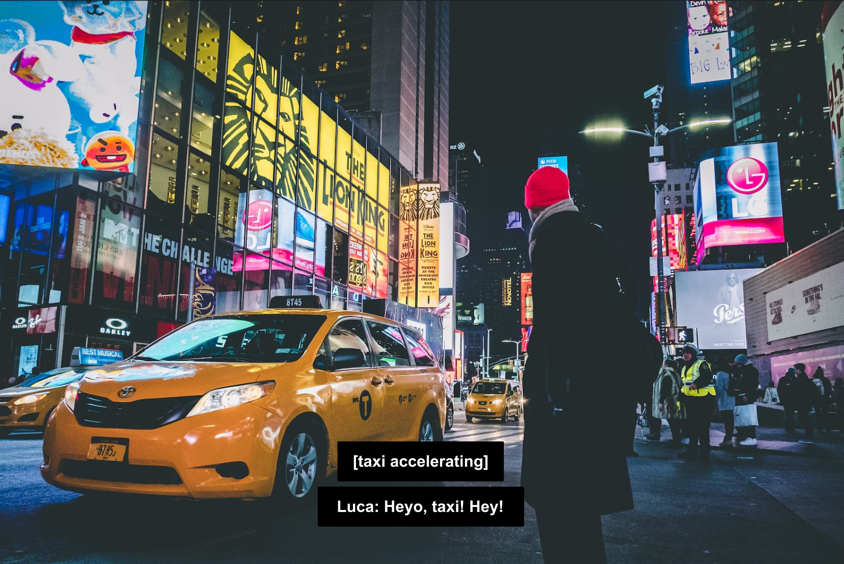 A person approaches a taxi at night, on a city street with numerous large video billboards lighting up the area.